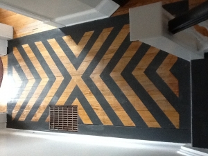 A wall with wooden planks painted black and brown.