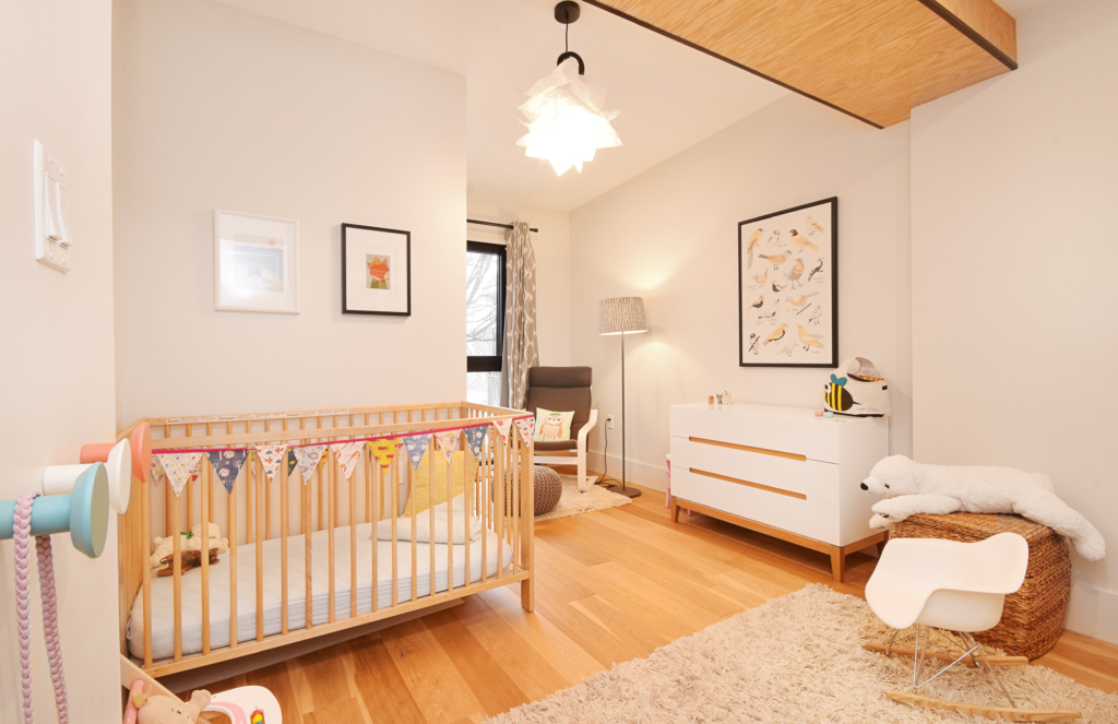 A baby room with a crib and dresser