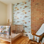A baby room with a crib and rocking chair.