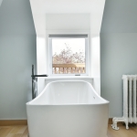A white tub sitting in the middle of a bathroom.