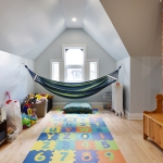 A room with a hammock and toys in it